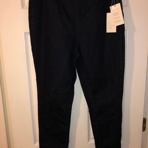 Dark blue tapered leg denim pants.